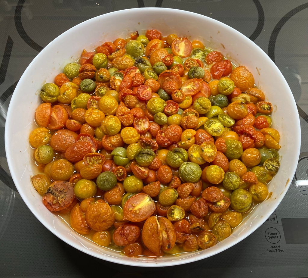 The casserole dish showing tomatoes starting yo dehydrate and roast